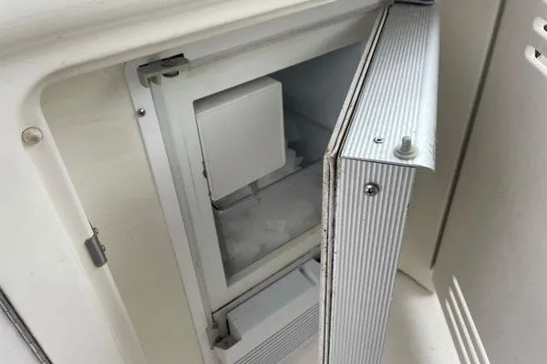 Slide: The Image of Open ice maker on 2003 Sea Ray 380 Sundancer yacht, showcasing interior details. - 16