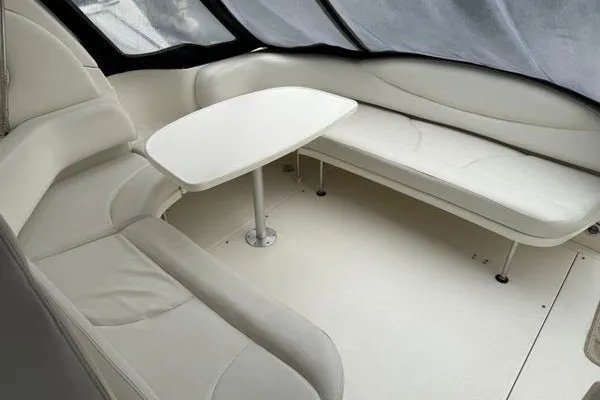 Slide: The Image of 2003 Sea Ray 380 Sundancer interior with white seating and table. - 10