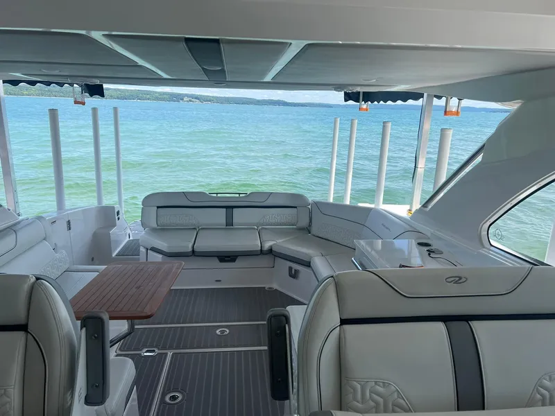 Slide: The Image of Luxurious 2022 Regal LS36 boat interior with elegant seating and scenic water view. - 14