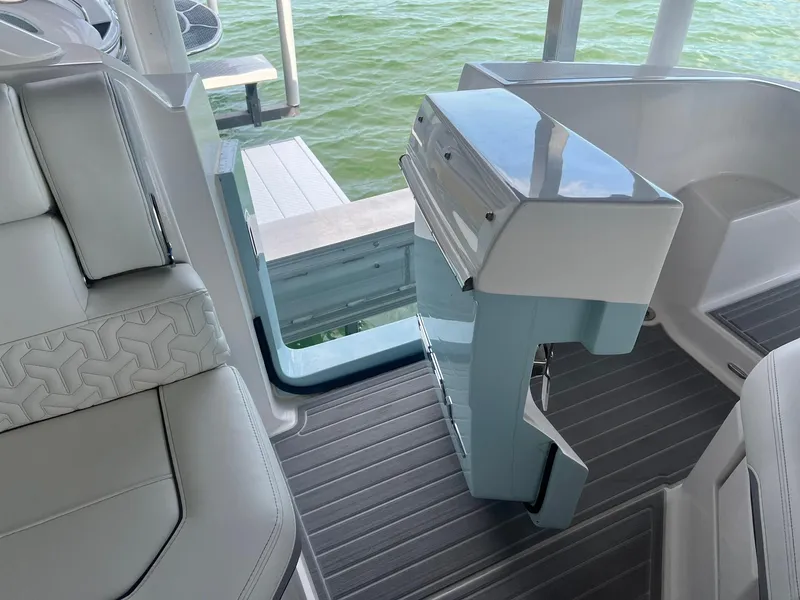 Slide: The Image of 2022 Regal LS36 boat interior with modern seating and sleek design near water. - 9