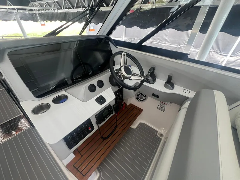 Slide: The Image of 2022 Regal LS36 boat helm with modern controls and sleek design. - 12