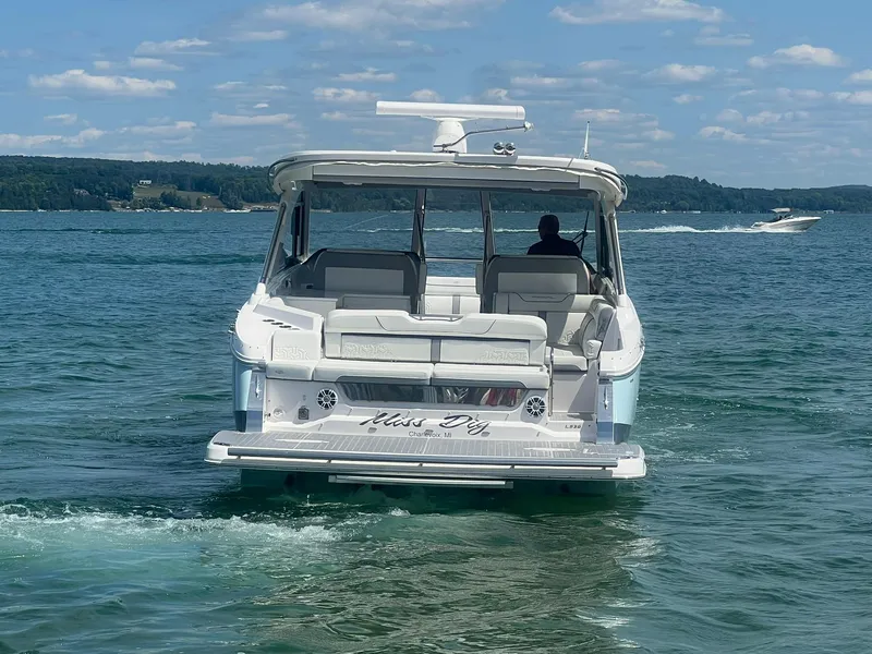 Slide: The Image of 2022 Regal LS36 boat cruising on a lake under a clear sky. - 6