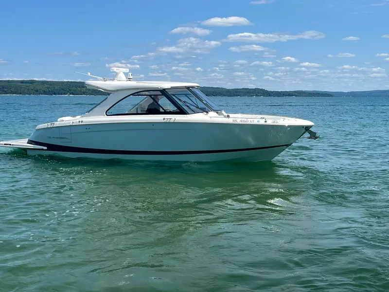 Slide: The Image of 2022 Regal LS36 boat cruising on a clear, sunny lake. - 1