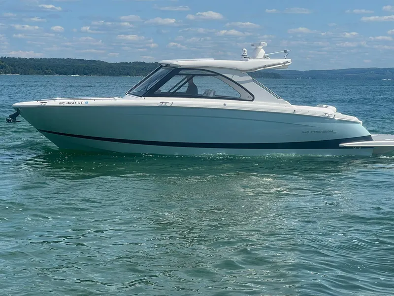 Slide: The Image of 2022 Regal LS36 boat on clear water under a blue sky. - 3