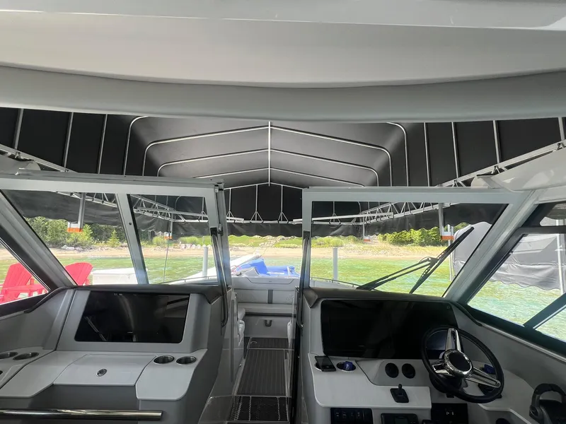 Slide: The Image of Interior view of 2022 Regal LS36 boat cockpit with modern controls and canopy. - 10