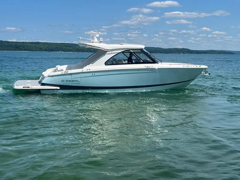 Slide: The Image of 2022 Regal LS36 boat cruising on a clear, sunny lake. - 35