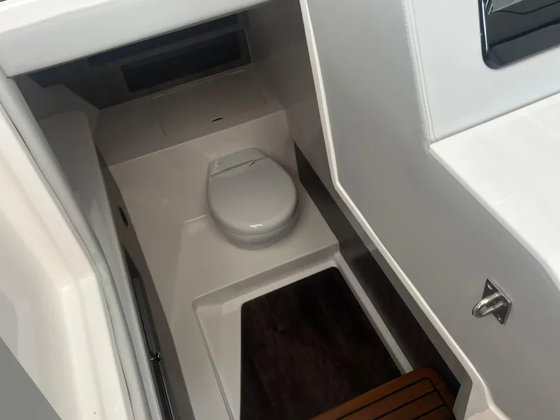 Slide: The Image of 2022 Regal LS36 boat interior with compact marine toilet and sleek design. - 26