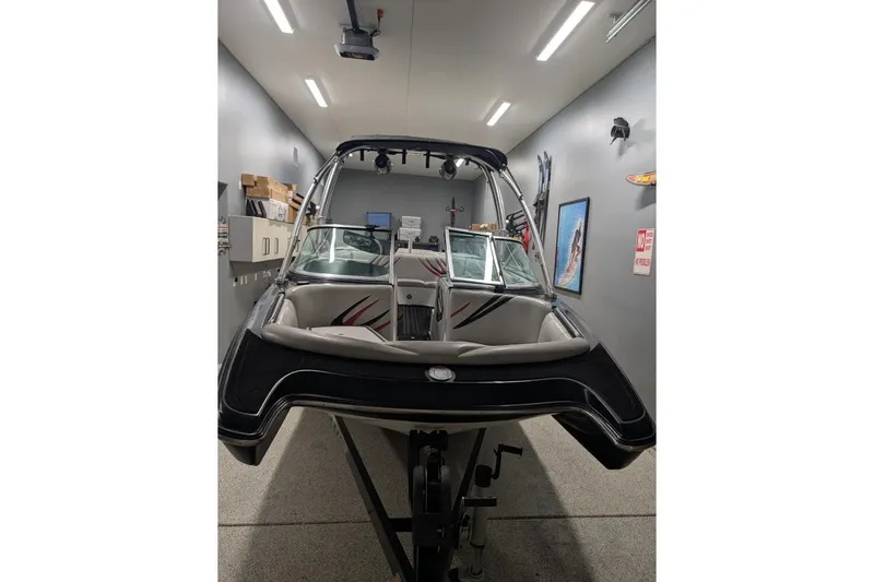 Slide: The Image of 2011 MB F21 Tomcat boat in a garage, featuring sleek design and modern interior. - 1