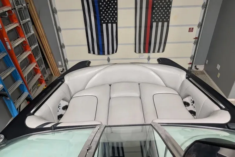 Slide: The Image of 2011 MB F21 Tomcat boat interior with white seating in a garage setting. - 5