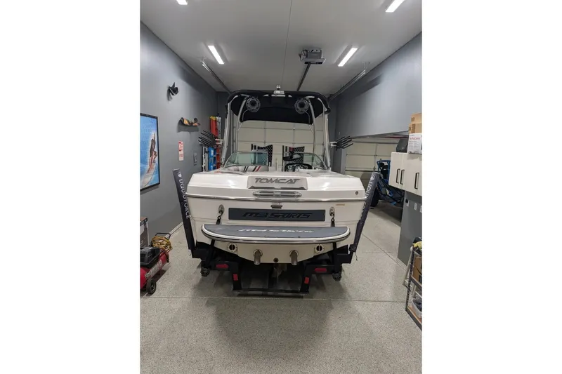 Slide: The Image of 2011 MB F21 Tomcat boat in a garage, rear view showcasing sleek design. - 3