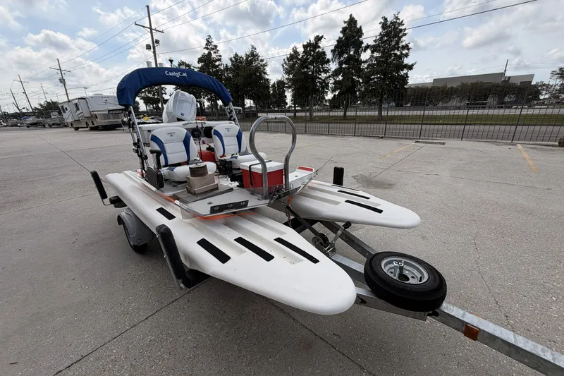 Slide: The Image of 2024 Craig Cat E2 Elite catamaran on trailer, featuring dual seats and canopy. - 4