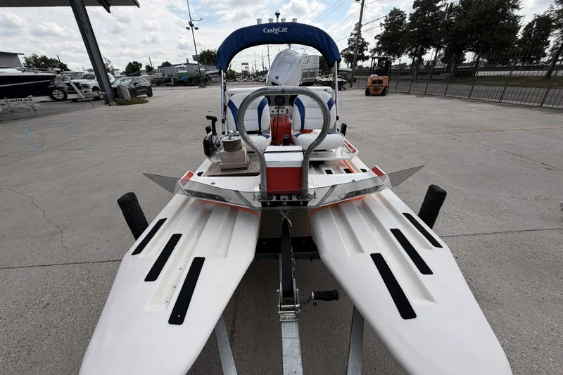 Slide: The Image of 2024 Craig Cat E2 Elite catamaran on trailer, parked outdoors under cloudy sky. - 3