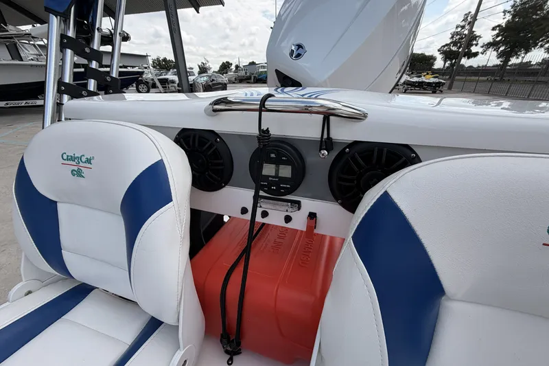 Slide: The Image of 2024 Craig Cat E2 Elite boat interior with blue and white seats, dashboard, and speakers. - 11