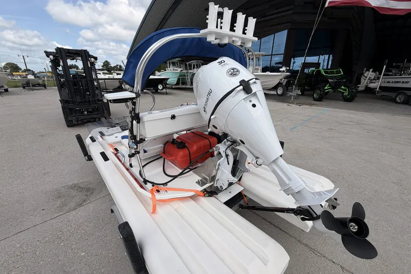 Slide: The Image of 2024 Craig Cat E2 Elite with outboard motor in a marina setting. - 9