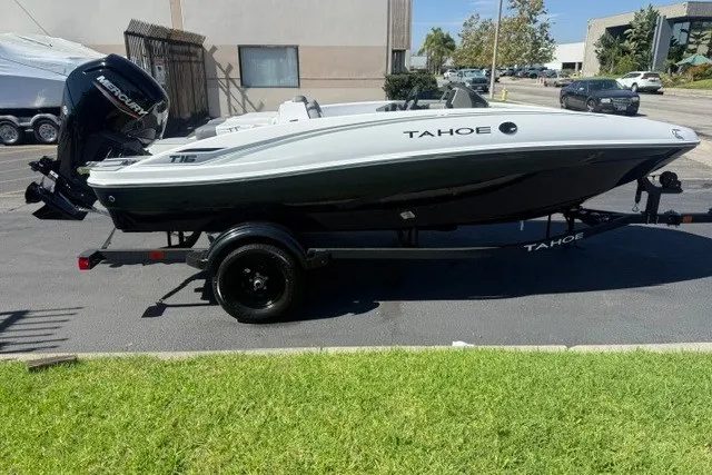 The Image of 2027 Tahoe T16 boat on trailer, parked outdoors, side view. - 0