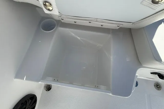 Slide: The Image of Interior compartment of 2027 Tahoe T16 boat, featuring storage space and cup holder. - 17