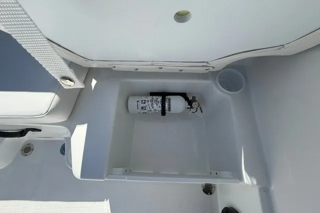 Slide: The Image of Fire extinguisher in storage compartment of 2027 Tahoe T16 boat. - 16