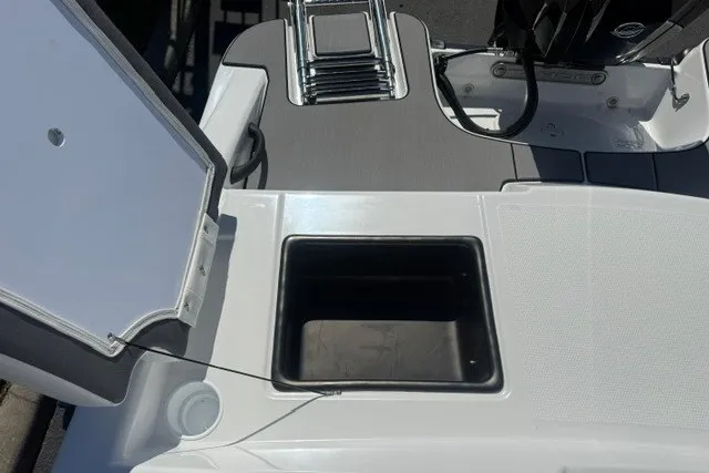 Slide: The Image of 2027 Tahoe T16 boat deck with open storage compartment and sleek design. - 21