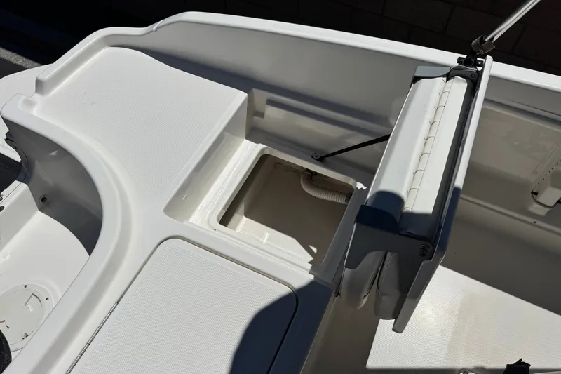 Slide: The Image of 2022 Trophy T18 Bay boat interior with open storage compartment and seating. - 18