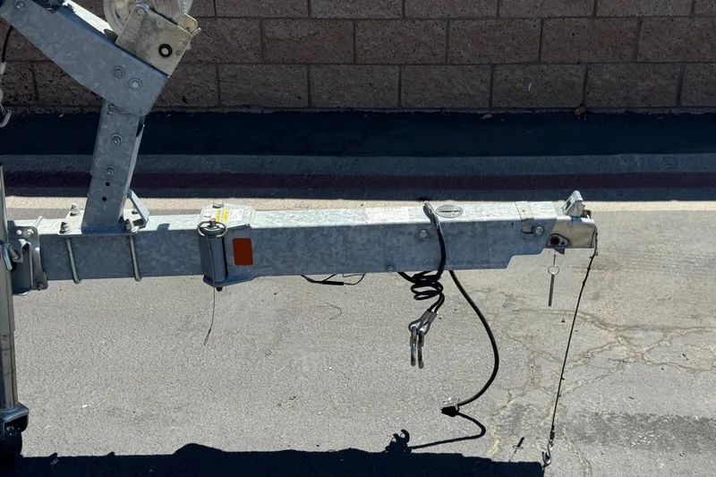 Slide: The Image of Trailer hitch of a 2022 Trophy T18 Bay boat on pavement background. - 26