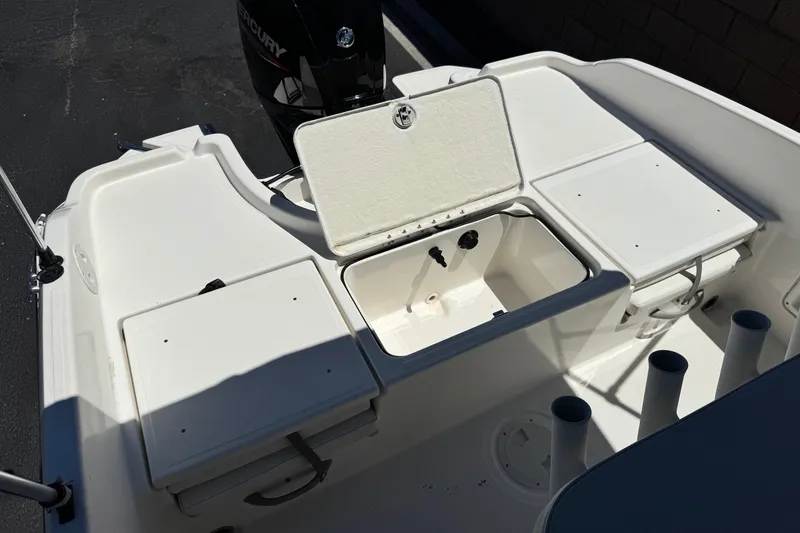 Slide: The Image of 2022 Trophy T18 Bay boat interior with storage compartments and Mercury engine. - 16