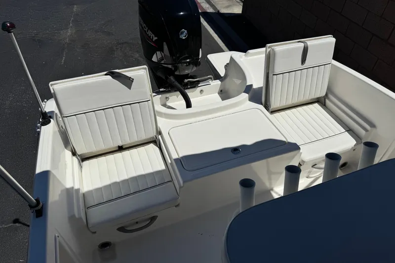 Slide: The Image of 2022 Trophy T18 Bay boat interior with white seating and Mercury engine. - 15