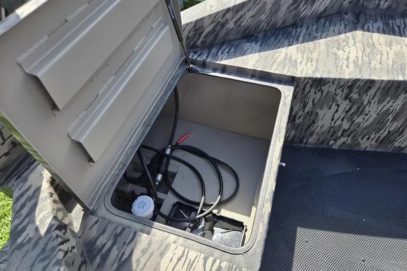 Slide: The Image of Open storage compartment in 2026 Havoc 1553 VJST boat, showing cables and interior. - 8