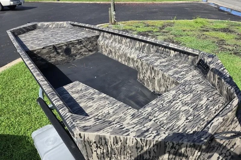 Slide: The Image of Camouflage-patterned Havoc 1553 VJST boat, 2026 model, parked on grass. - 11