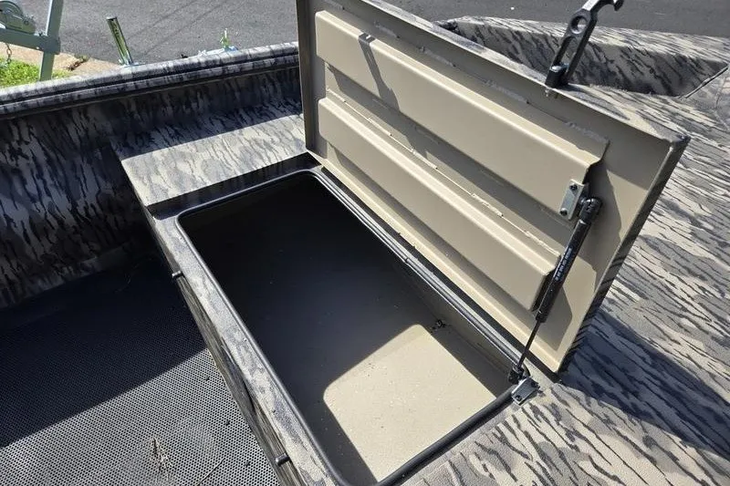 Slide: The Image of Open storage compartment in 2026 Havoc 1553 VJST boat, featuring camo interior design. - 7