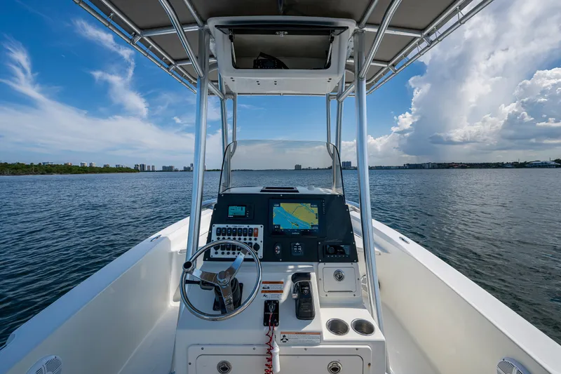 Slide: The Image of 2010 Hydra-Sports Bay Bolt 23 boat dashboard with navigation system on open water. - 11