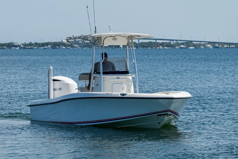 Slide: The Image of 2010 Hydra-Sports Bay Bolt 23 boat cruising on calm waters with bridge in background. - 18
