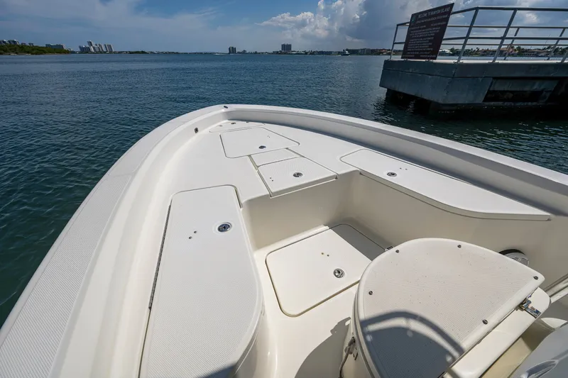 Slide: The Image of 2010 Hydra-Sports Bay Bolt 23 boat deck with storage compartments, docked by the water. - 5