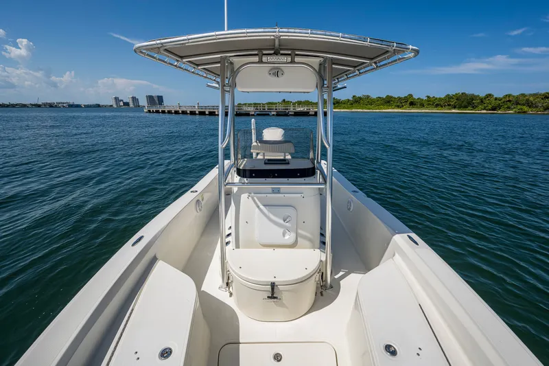 Slide: The Image of 2010 Hydra-Sports Bay Bolt 23 boat on calm water, featuring a sleek design and spacious deck. - 8