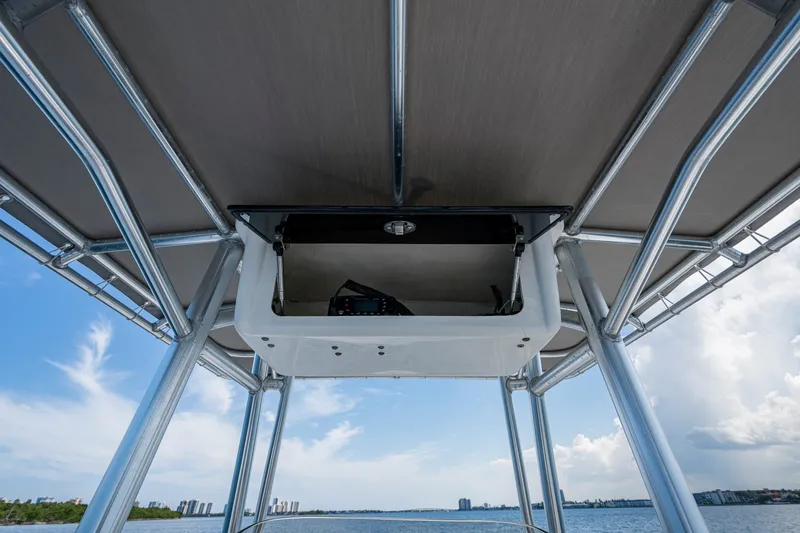 Slide: The Image of 2010 Hydra-Sports Bay Bolt 23 boat canopy with electronics, overlooking a scenic waterfront. - 13