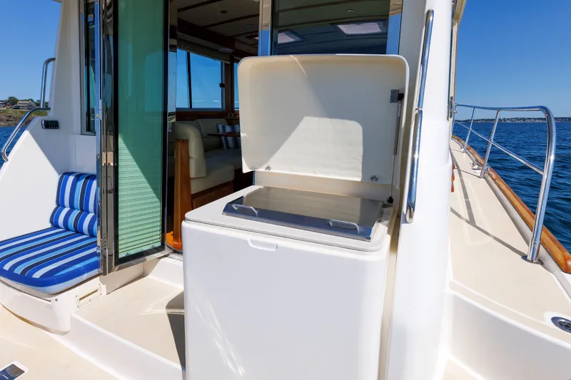 Slide: The Image of 2013 Sabre 42 Salon Express yacht with open deck hatch and striped seating. - 23