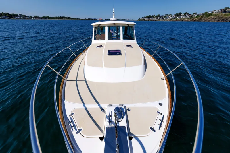 Slide: The Image of 2013 Sabre 42 Salon Express yacht cruising on open water, showcasing sleek design and spacious deck. - 14