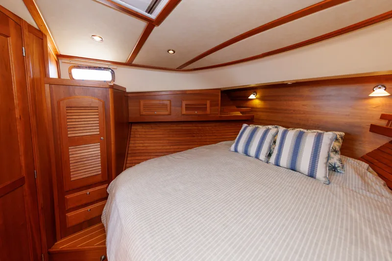 Slide: The Image of Luxurious cabin interior of 2013 Sabre 42 Salon Express with cozy bedding and wooden accents. - 34