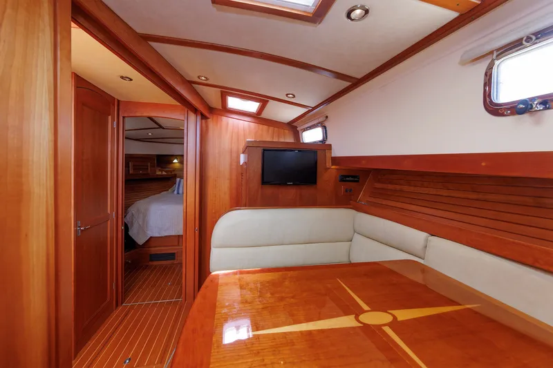 Slide: The Image of Luxurious interior of 2013 Sabre 42 Salon Express yacht with wood finish and seating area. - 38