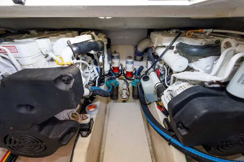 Slide: The Image of Engine room of a 2013 Sabre 42 Salon Express, showcasing dual engines and mechanical components. - 48