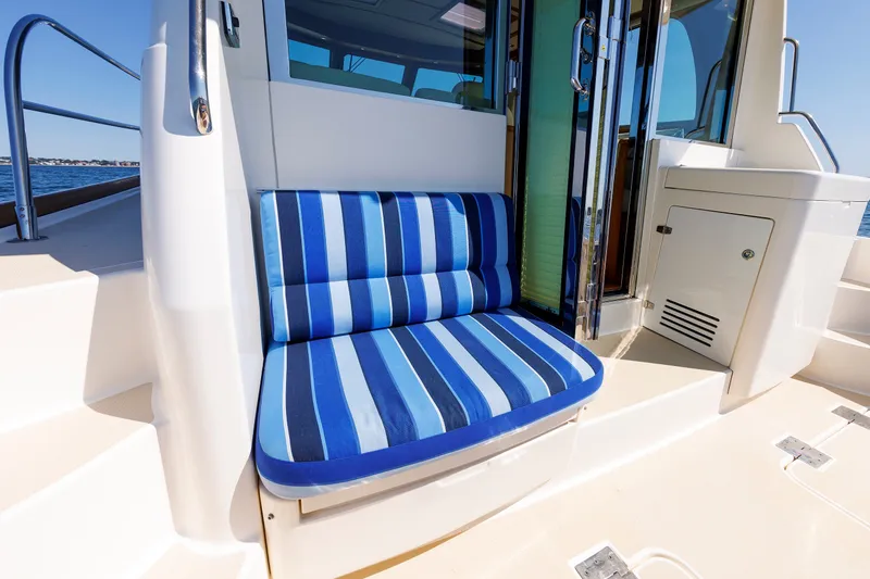 Slide: The Image of Blue-striped seating on 2013 Sabre 42 Salon Express yacht, near cabin entrance. - 21