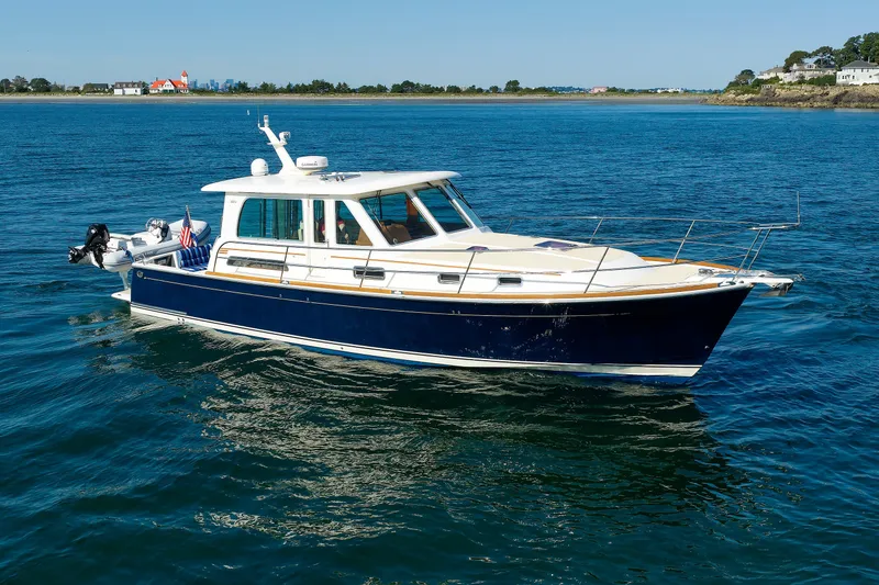Slide: The Image of 2013 Sabre 42 Salon Express yacht cruising on calm blue waters. - 4