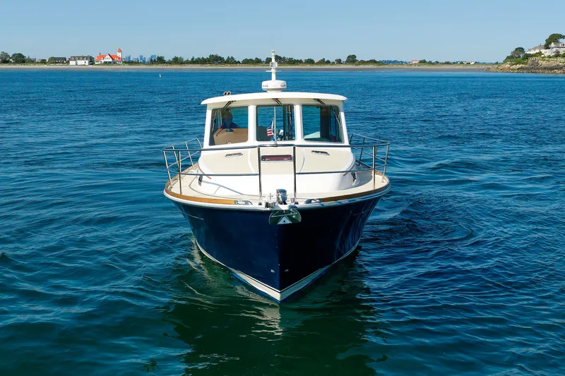 Slide: The Image of 2013 Sabre 42 Salon Express yacht on calm blue water, front view. - 5