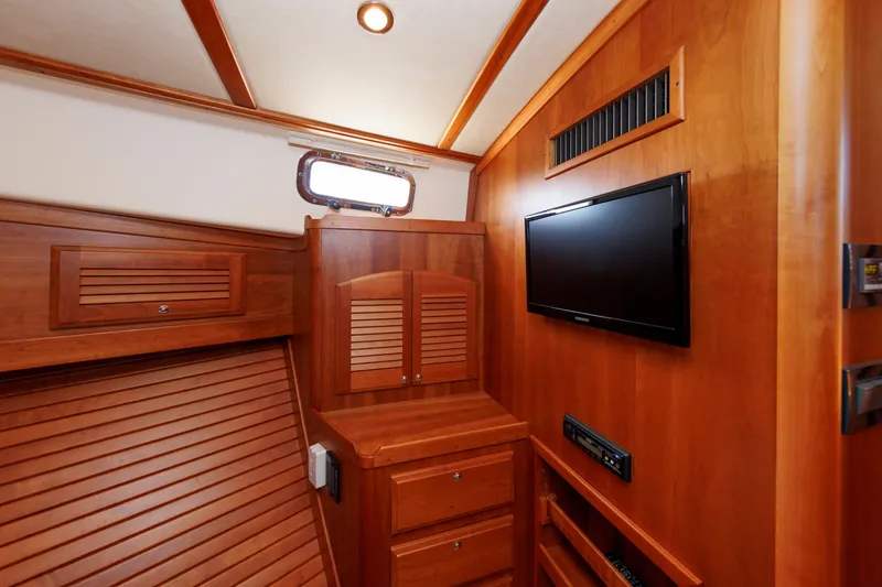 Slide: The Image of Interior of 2013 Sabre 42 Salon Express with wood paneling and mounted TV. - 36