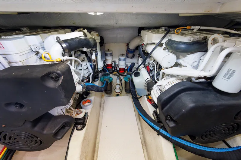 Slide: The Image of Engine room of a 2013 Sabre 42 Salon Express, showcasing dual engines and components. - 50