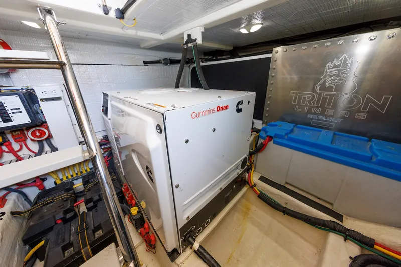 Slide: The Image of Engine room of 2013 Sabre 42 Salon Express with Cummins Onan generator and Triton Liners panel. - 43