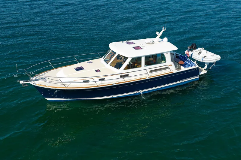 Slide: The Image of 2013 Sabre 42 Salon Express yacht on calm blue water. - 1