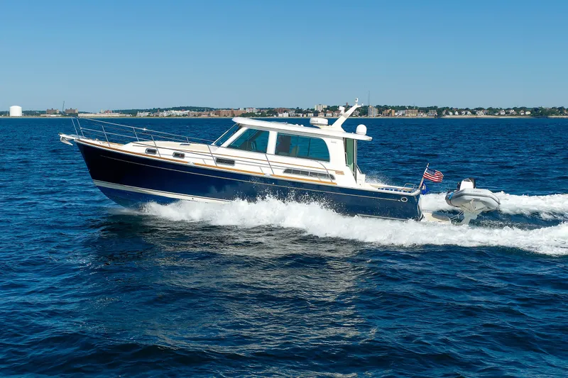 Slide: The Image of 2013 Sabre 42 Salon Express cruising on open water under clear blue skies. - 10