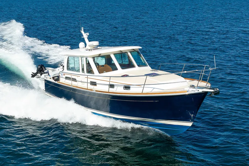 Slide: The Image of 2013 Sabre 42 Salon Express cruising on open water, showcasing sleek design and performance. - 8