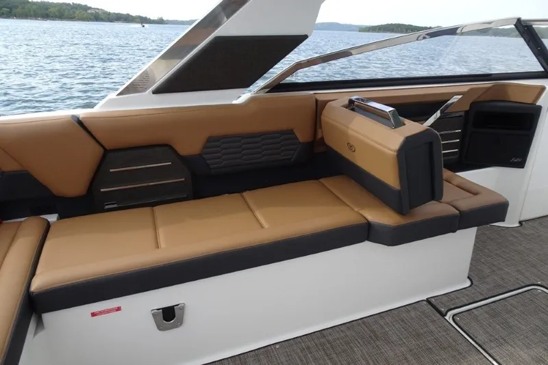Slide: The Image of Luxurious seating on 2022 Cobalt A29 boat with tan and black upholstery, overlooking serene water. - 15