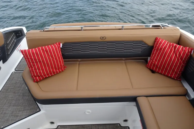 Slide: The Image of Luxurious seating on 2022 Cobalt A29 boat with red striped cushions, overlooking water. - 35